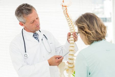 chiropractor explaining procedure to patient